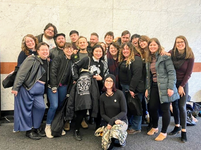A group of smiling people, posing for the camera.